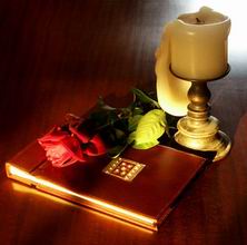 “Book, rose and candle on teak” by Liam Quin